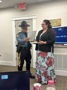 Chief McCloskey performing his swearing in and taking the Oath. To the right of Chief McCloskey is Town Manager, Julie Goodyer holding the Bible for Chief.